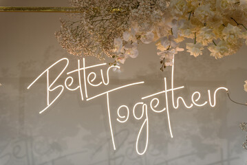 Better together text on photo-wall. Arch decorated flowers, greenery. Wedding reception....
