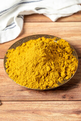 Curry Masala Powder. Turmeric powder or curry powder spice in a bowl on wooden background. İndian spices. Dry spice concept. close up