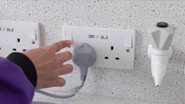 scientist plugging in microscope uk plug socket switching on