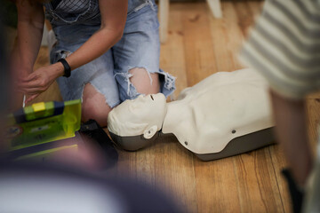 Mannequin for first aid training. First aid cardiopulmonary resuscitation course using automated external defibrillator device, AED.
