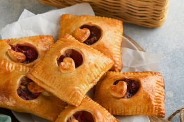 Valentines day heart shaped Hand pies. Mini puff pastry or hand pies stuffed with apple and sprinkle sugar powder in plate. Idea for homemade romantic snack Valentines day. Top view. Copy space.