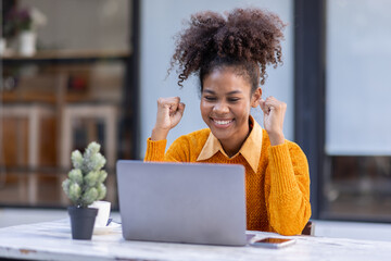 Portrait of Happy smiling african american businesswoman, adorable girl using laptop browsing web drinking coffee in cafe restaurant outdoors