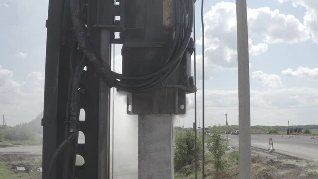Pile driving machine driving piles into ground site. Modern hydraulic lifting mechanisms. Ukraine. 