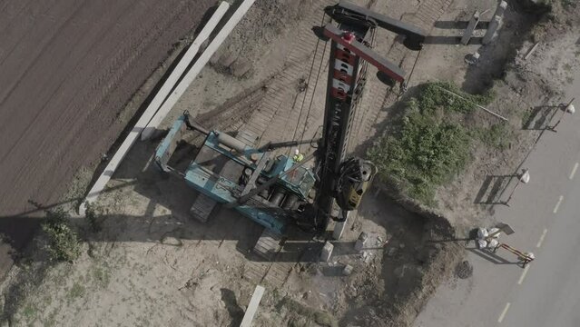 Pile driving machine driving piles into ground site. Modern hydraulic lifting mechanisms. Ukraine. 