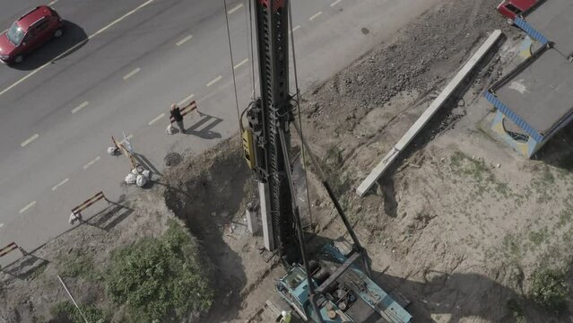 Pile driving machine driving piles into ground site. Modern hydraulic lifting mechanisms. Ukraine. 
