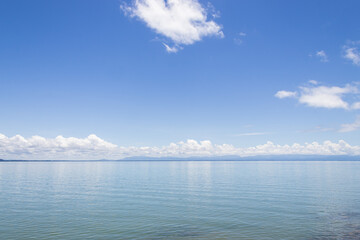 Morning sky and sea, bright white clouds, daytime, relaxing feeling, with copy space, suitable for use as a background image.