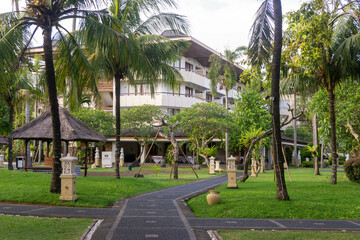 Fototapeta premium Hotel building with beautiful garden in front of it
