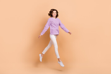Fototapeta na wymiar Full length photo of graceful lovely lady wear comfort trendy clothes moving empty space store center isolated on beige color background