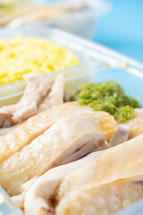 angle view two packs of Hainanese chicken rice at vertical composition