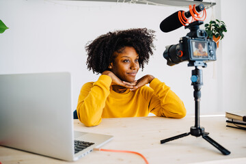 Focused African American woman recording podcast