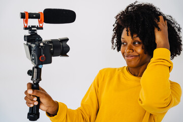 Content black woman recording video on camera
