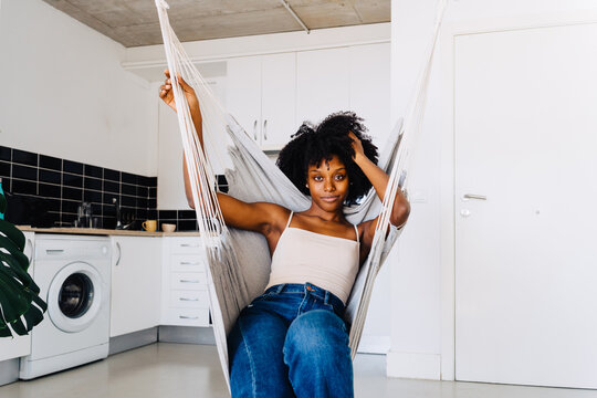 Black woman resting on hammock