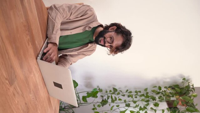 Thoughtful young man writer journalist create new article sit at home office desk with laptop