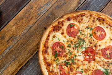 Margherita pizza or Margarita pizza on wooden background. Close up homemade fresh Italian Margherita or Margarita pizza with cheese, gourmet, basil. Pizza is traditional food for Italian on Italy.