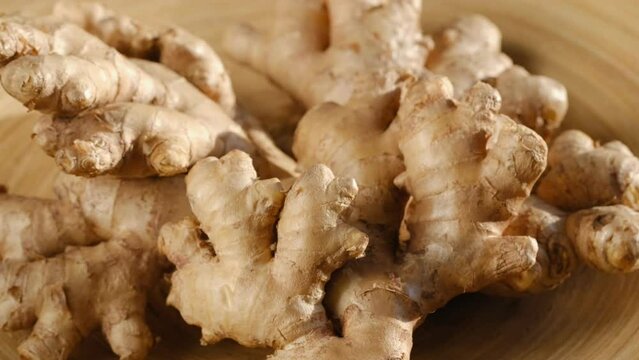 Whole ginger root on close up rotating 