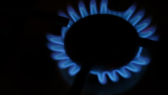 Blue fire gas stove. Gas burner close-up. Gas stove. gas burner Ukraine without light. Cooking at home.