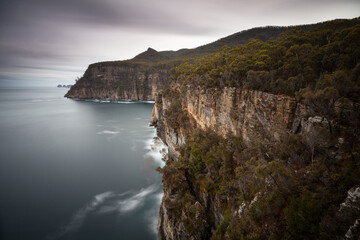 The cliffs of Waterfall Bay, Tasmania - on the horizon Cape Hauy - The Laterns
