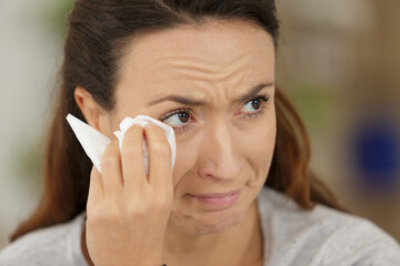 sad woman drying the tears