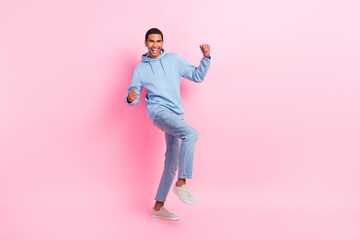 Fototapeta na wymiar Photo of overjoyed positive man wear stylish clothes rejoice win lottery jackpot raise fist empty space isolated on pink color background