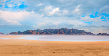 Panoramic view of orange sand dune desert with orange mountains and hill - Namib desert, Namibia