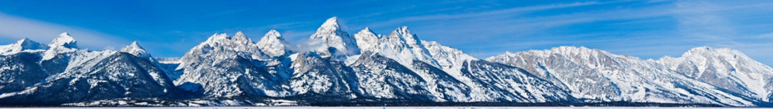 Wide Panorama of snow covered Grand Teton Mountains near Jackson Wyoming.