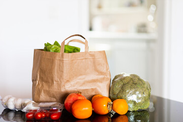 fresh food in a bag on the table, in the kitchen, space for text