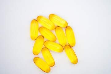 yellow capsule pills on a white background