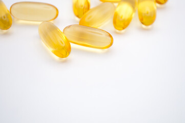 yellow capsule pills on a white background