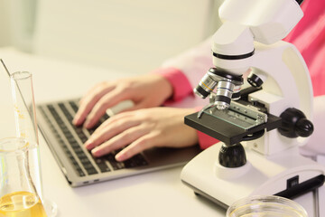 Female hands laboratory typing on keyboard, close-up