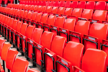 red plastic chair in football, basketball or baseball arena stadium in a row for visitor to visit and enjoy sport match competition for big football match in football stadium
