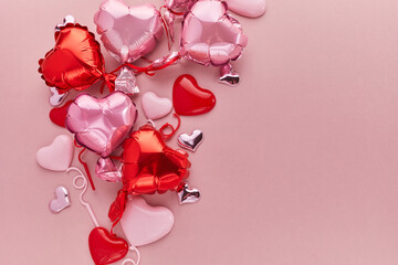 Air Balloons of heart shaped foil on pink background. Love concept. Valentine's Day.
