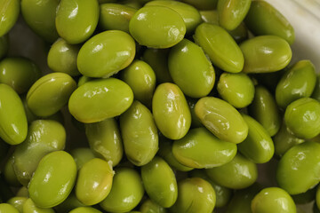 Peeled fresh steamed green soy beans edamame. Japanese plant snack. extreme close up. Top view