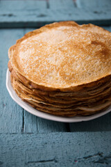 Delicious thin ruddy pancakes in a plate