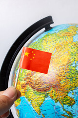 Chinese flag on background of globe with map