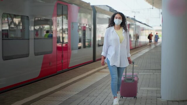 Girl passenger in mask arrived to the destination station