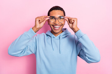 Fototapeta premium Photo of excited funny positive satisfied man toothy smile tries his new eyeglasses vision correction ophthalmolog isolated on pink color background