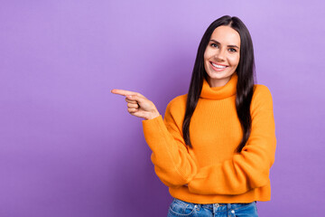 Photo of young cheerful positive lady wear orange pullover direct finger empty space useful tips...