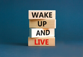Wake up and live symbol. Concept words Wake up and live on wooden blocks. Beautiful grey table grey background. Business lifestyle wake up and live concept. Copy space.