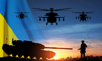 Fototapeta na wymiar Silhouettes of a soldiers and a main battle tank on a battlefield with military helicopters in sky with Ukraine flag against the sunset. EPS10 vector