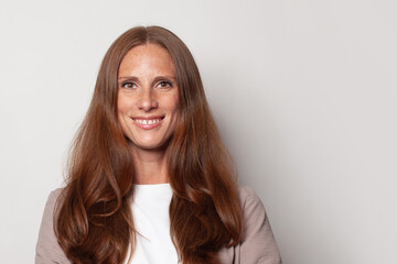 Fototapeta premium Happy smiling confident mid adult woman portrait. Beautiful female face closeup.