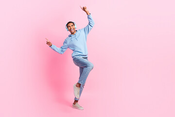 Fototapeta na wymiar Full length photo of positive glad man wear stylish clothes look empty space sale modern technology shop isolated on pink color background