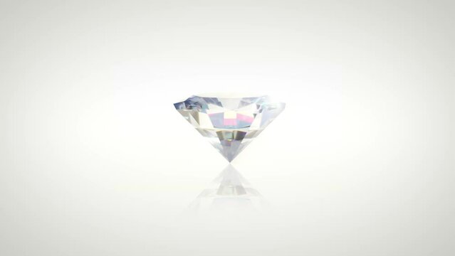 Diamond Rotating on a white background. 4K render of a beautiful round brilliant diamond shining as it spins in 3D.