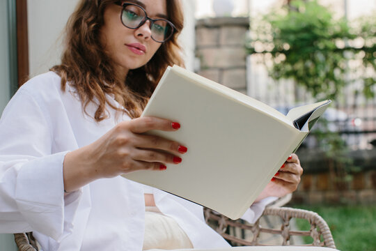Mockup image magazine book. The girl at the coffee shop table reading magazine.
