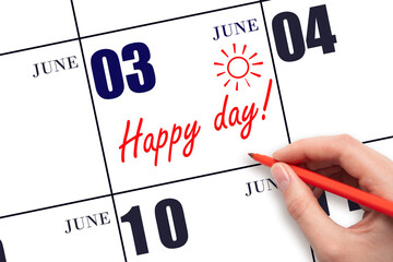 Hand writing the text HAPPY DAY and drawing the sun on the calendar date June 3