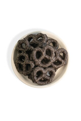 Styled Bulk Vintage Candy. Round Dish Filled with Dark Chocolate Pretzels. Candy on White Background. Vertical Image with Copy Space.