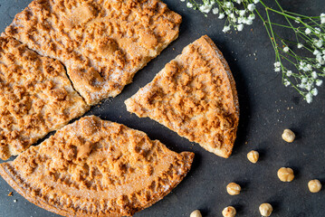 Fregolotta, a traditional italian crumb cake or pie is seen from top on a table. Traditional dessert from the Veneto region and Venice, made with flour, eggs, butter, sugar.