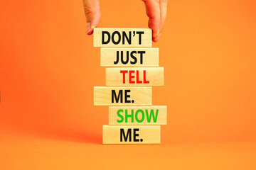Tell or show symbol. Concept words Do not just tell me, show me on wooden blocks. Beautiful orange...