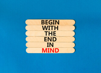 Begin in end of mind symbol. Concept words Begin with the end in mind on wooden stick. Beautiful blue table blue background. Business begin in end of mind concept. Copy space.