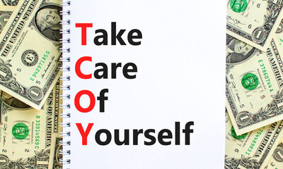 TCOY take care of yourself symbol. Concept words TCOY take care of yourself on white note on beautiful white background. Dollar bills. Business TCOY take care of yourself concept. Copy space.