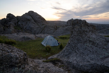 Camping in the rock massif Los Gigantes in Cordoba, Argentina, at sunset. View of the tent, rocky...